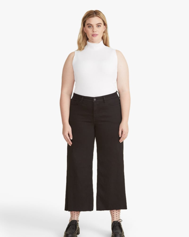 Front of a model wearing a size 14 Courtney High-Waist Wide-Leg Jeans in Black by Warp + Weft. | dia_product_style_image_id:248828